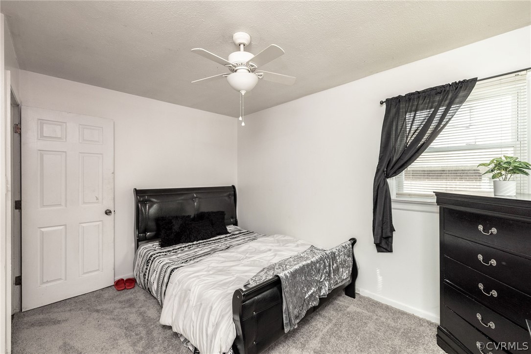 Bedroom 2 with ceiling fan and overhead light.