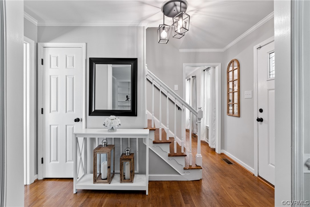 Foyer with coat closet, central hall, staircase, a