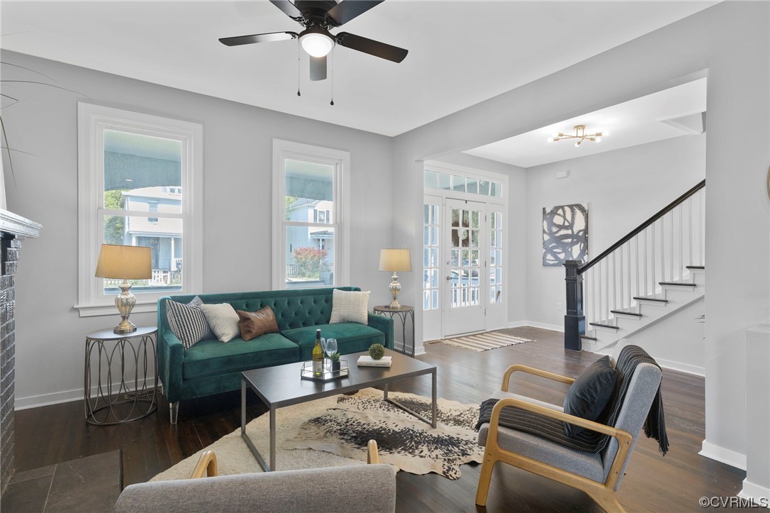 Living room and entry featuring hardwood flooring
