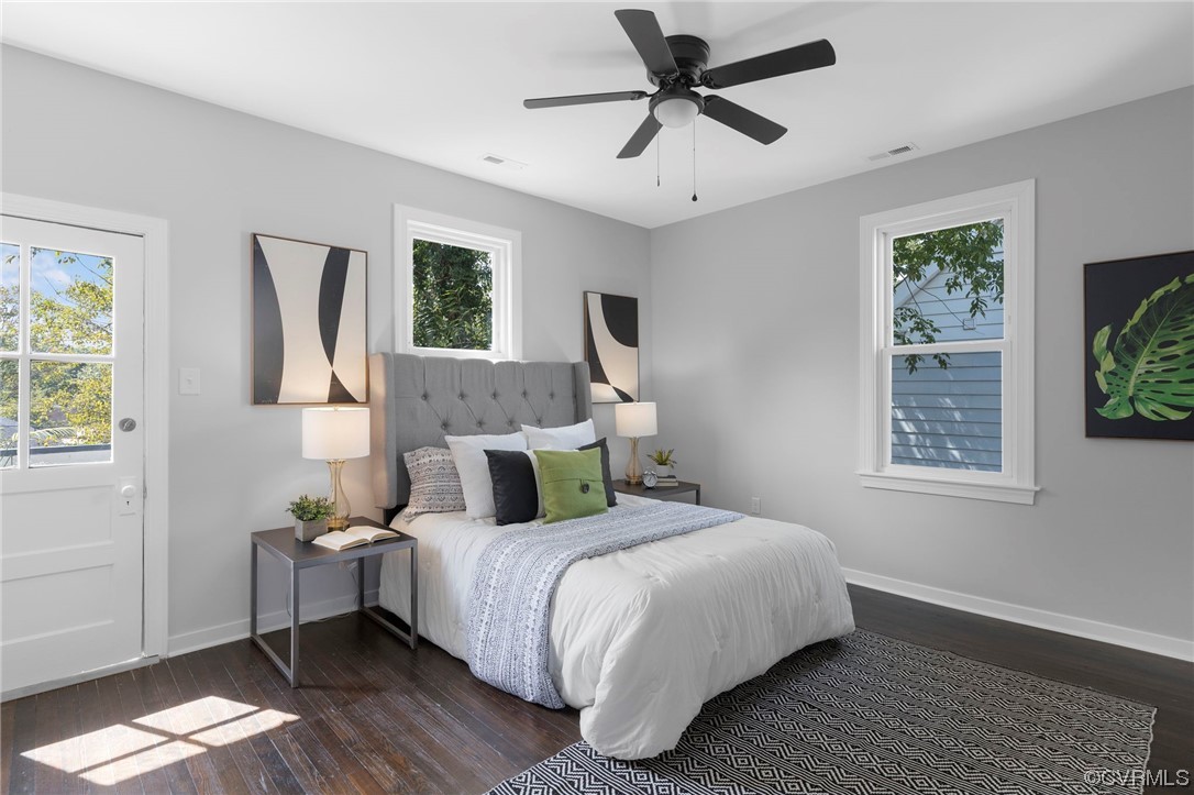 Spacious primary bedroom features ceiling fan, en-