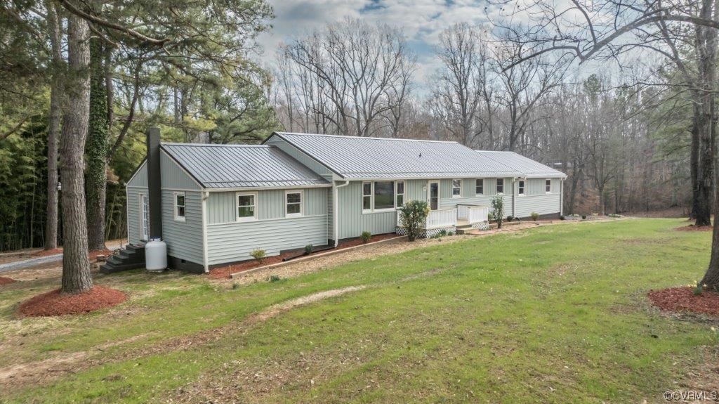 Rear view of property featuring a lawn