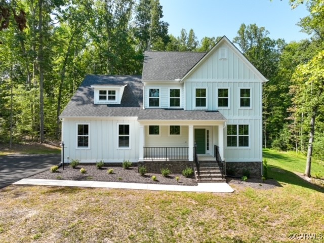 Modern inspired farmhouse with covered porch and a