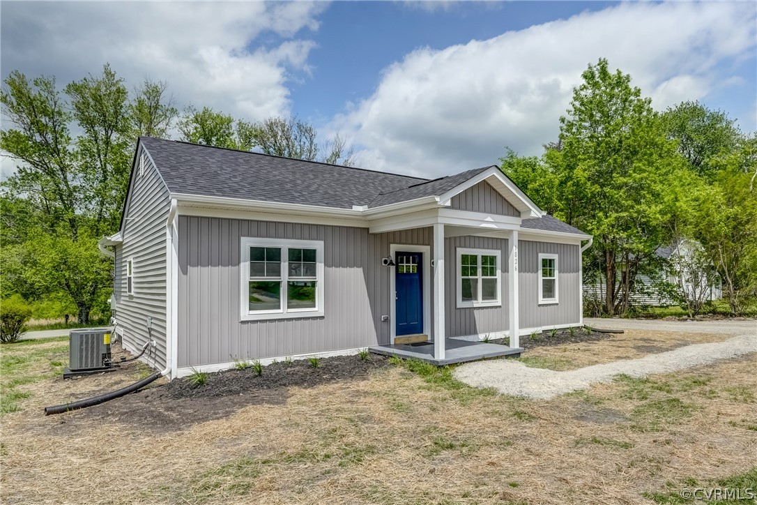 View of front of property featuring central AC uni