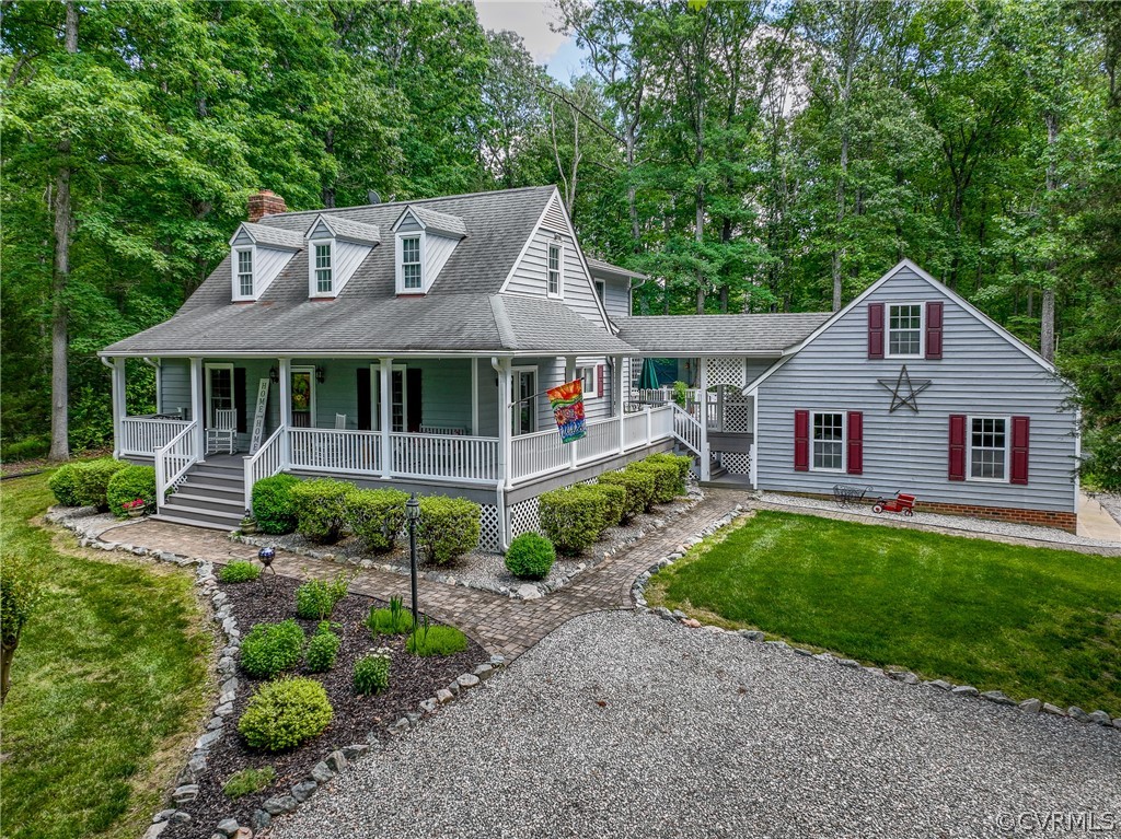 New england style home featuring a porch