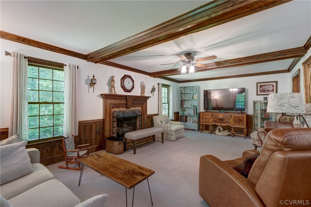 Carpeted living room featuring ornamental molding