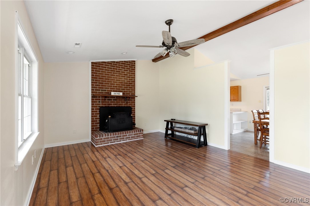 Unfurnished living room with vaulted ceiling, dark