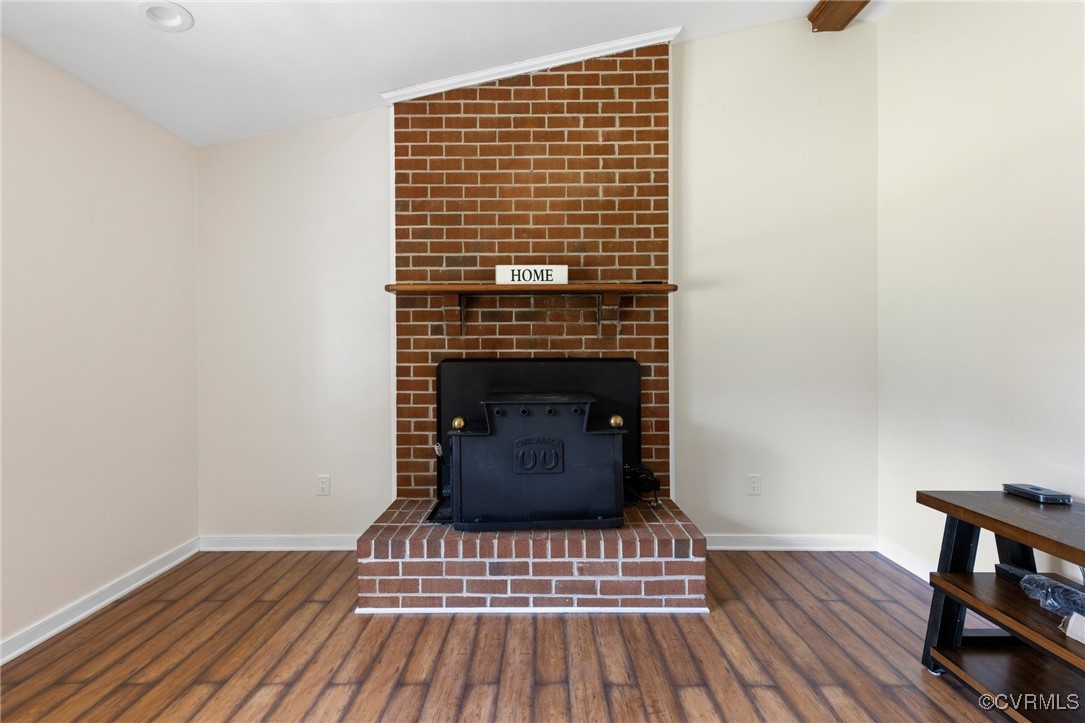 Room details featuring a wood stove, wood-type flo