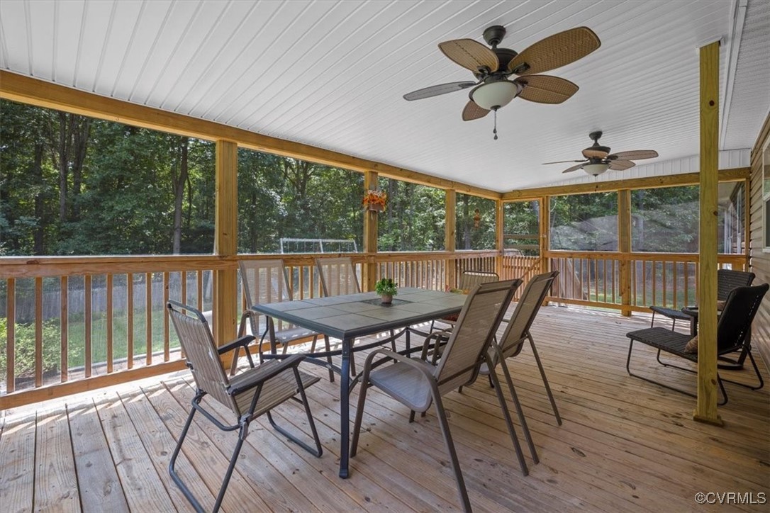 Sunroom / solarium featuring ceiling fan