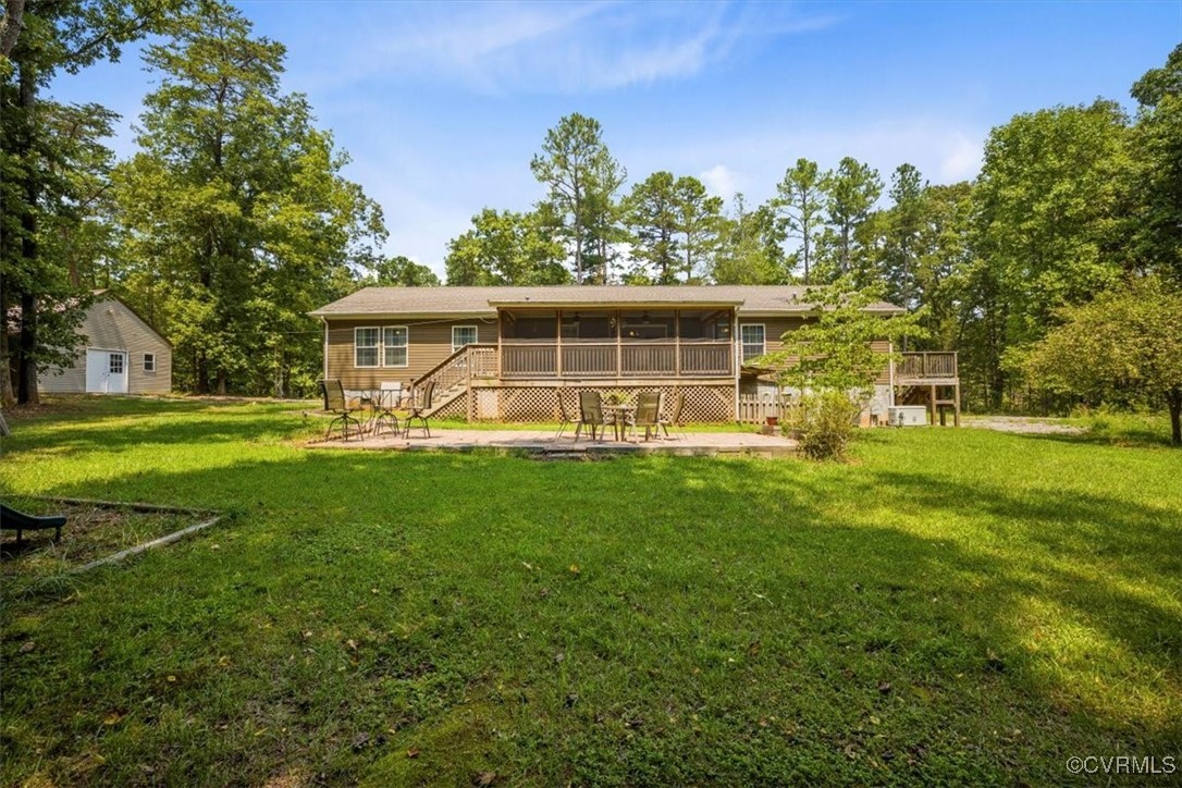 Rear view of property with a yard and a Patio