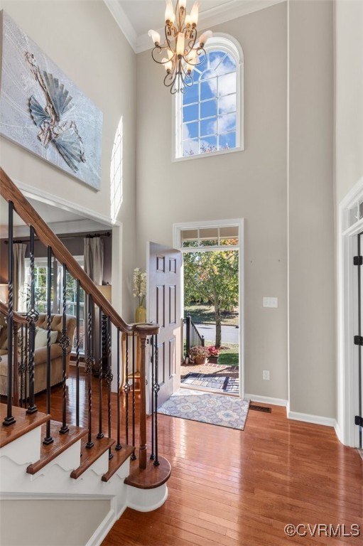 Foyer entrance with ornamental molding, a chandeli