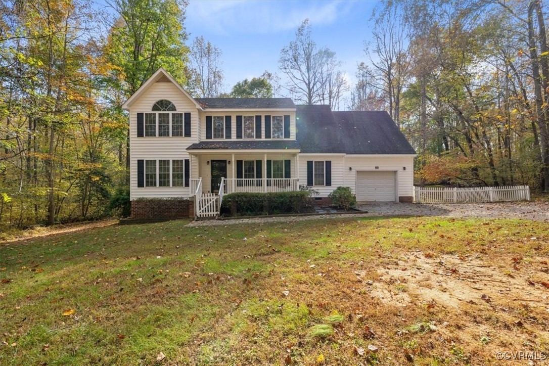 View of front of property with covered porch, a fr
