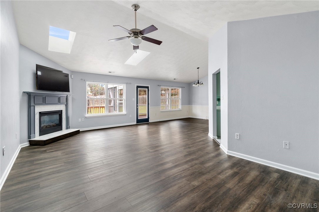 Unfurnished living room with ceiling fan with nota