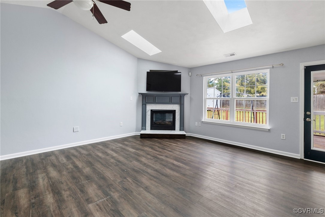 Unfurnished living room featuring lofted ceiling w