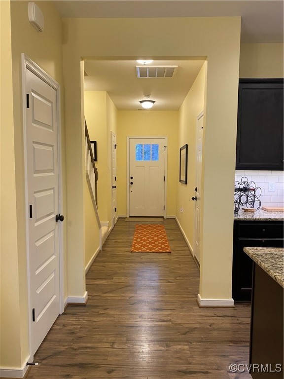 Doorway to outside featuring dark hardwood / wood-