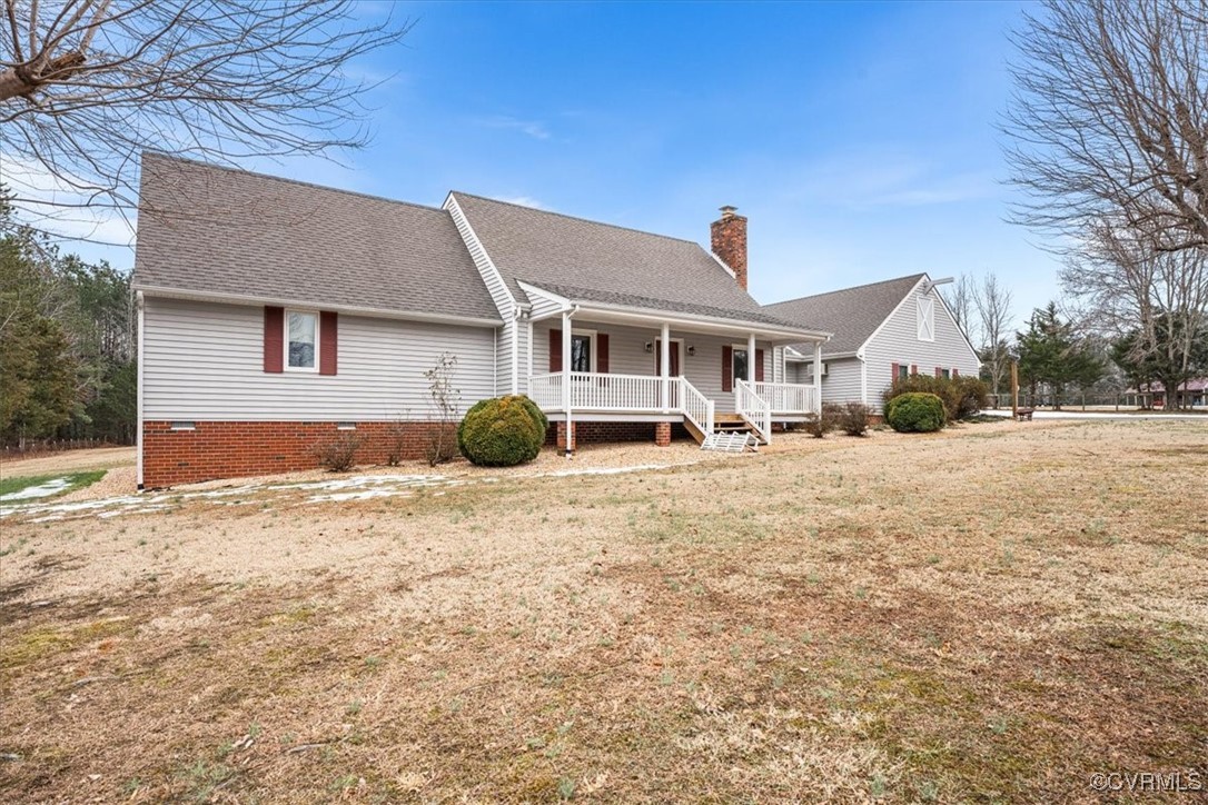 View of front facade with a front yard and a porch