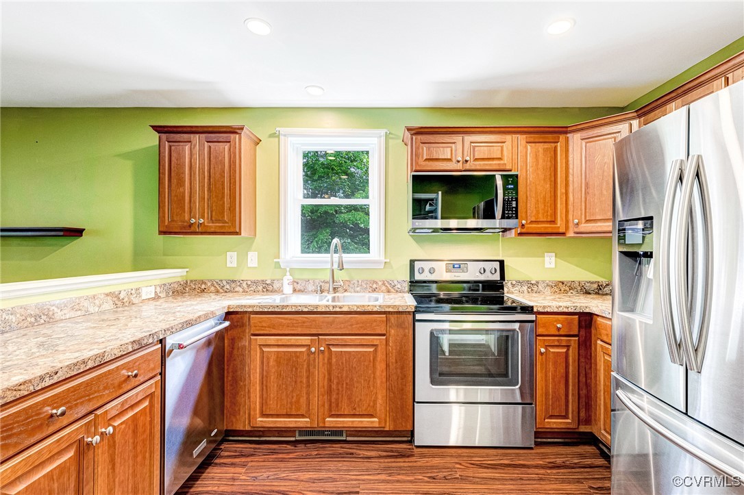 Kitchen featuring stainless steel appliances, a si