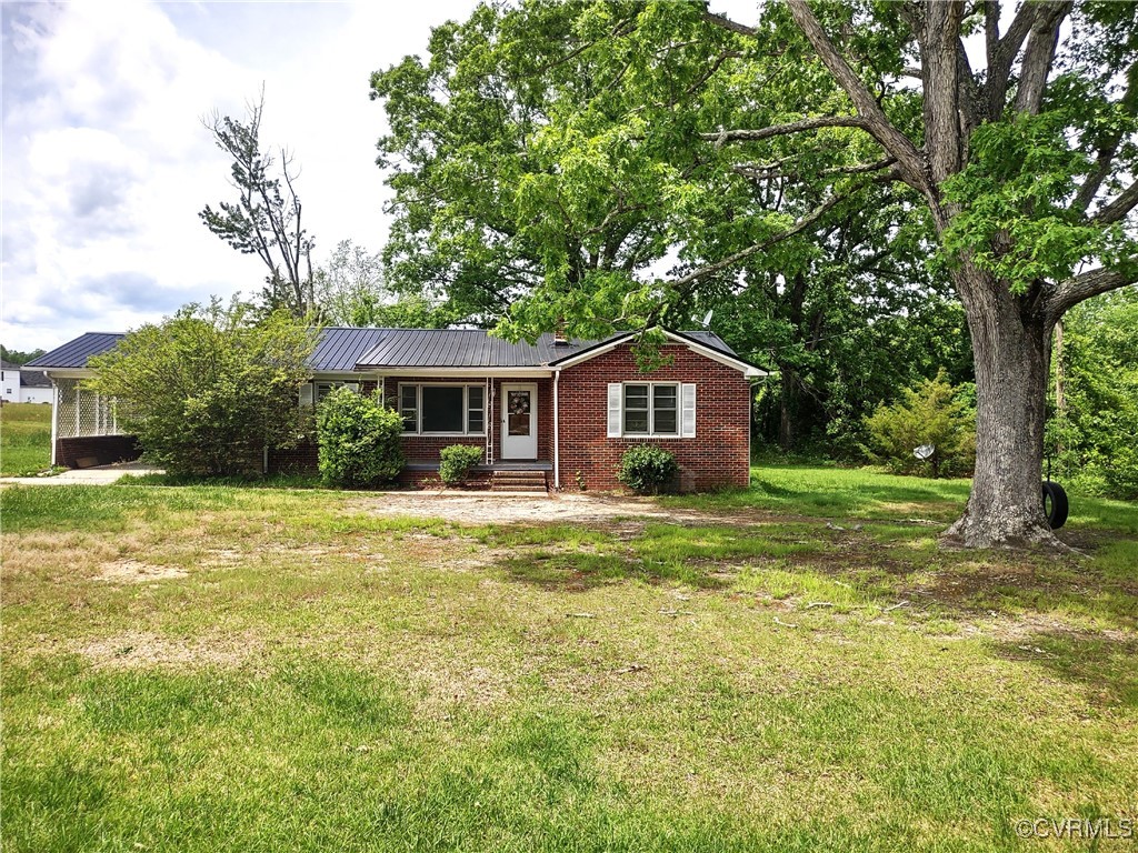 Single story home featuring brick siding, a front