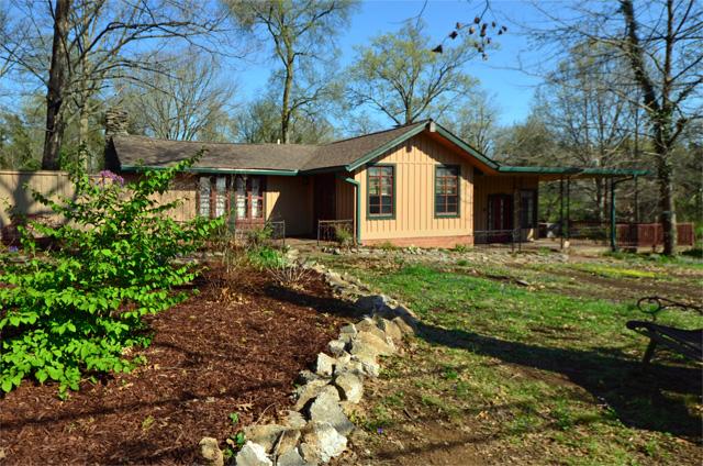 This custom built home is situated on a picturesque fenced corner lot across form the Cumberland River.