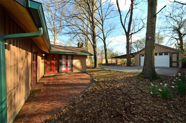 The oversize garage with power has an opener and workshop area, and there is a large carport and aggregate drive.