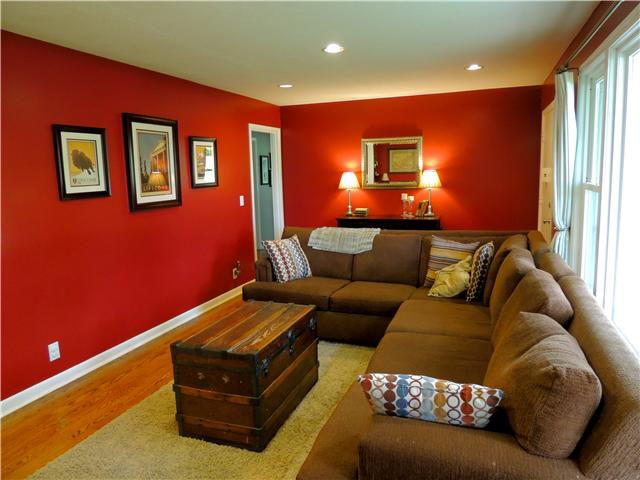Standing near the kitchen with full view of the living room.