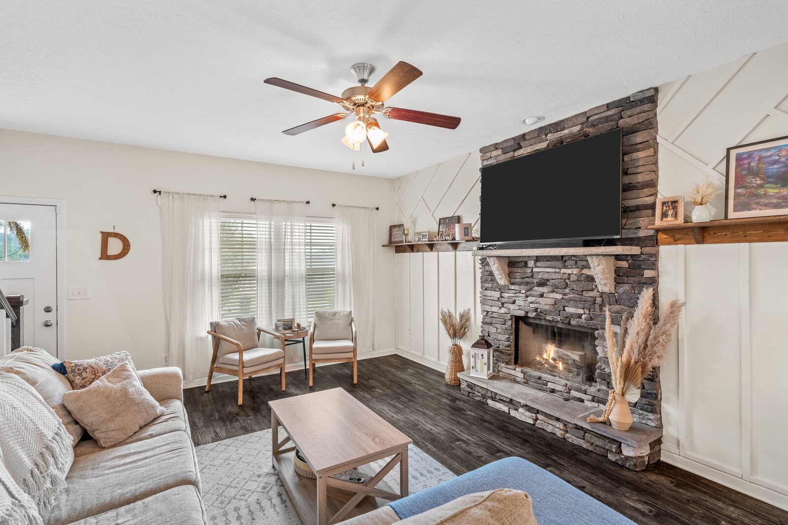 Freshly painted with a beautiful stone fireplace.  A warm welcome into a beautiful home.