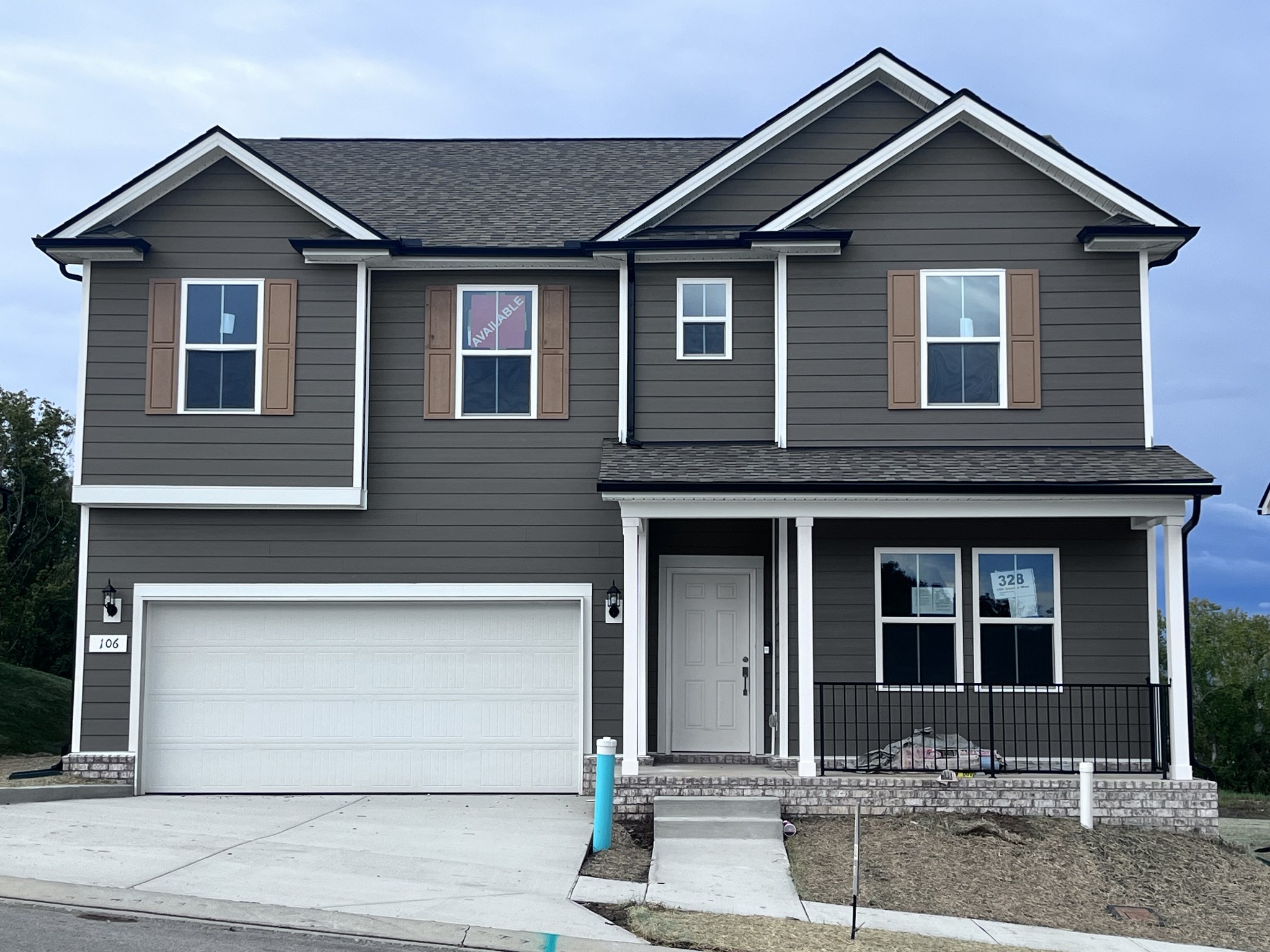 Hampton Home / Homesite 328: Added the optional Covered front porch and Upgraded Roof peaks and shutter accents for beautiful curb appeal!  Evokes a woodsy feel with the popular warm Timberbark exterior color. Door and Shutters to be painted black.
