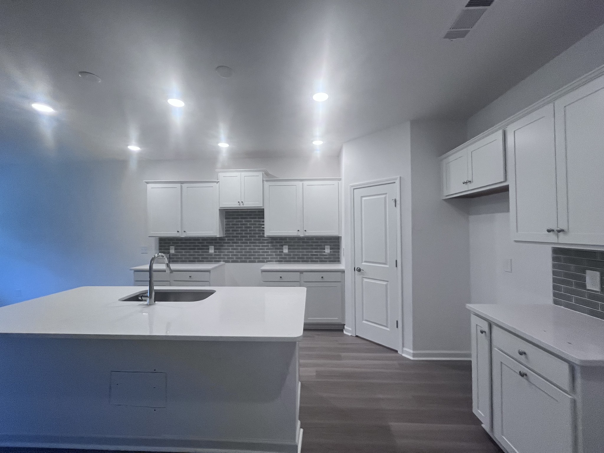 Hampton  homes include the 7 ft Kitchen Island to make hosting & gathering easy! Home # 328 has been UPGRADED: Premier Fresh Design Collection in the Kitchen:quartz topped counters, white cabinets and soft-close doors & drawers, plus roll out trays!