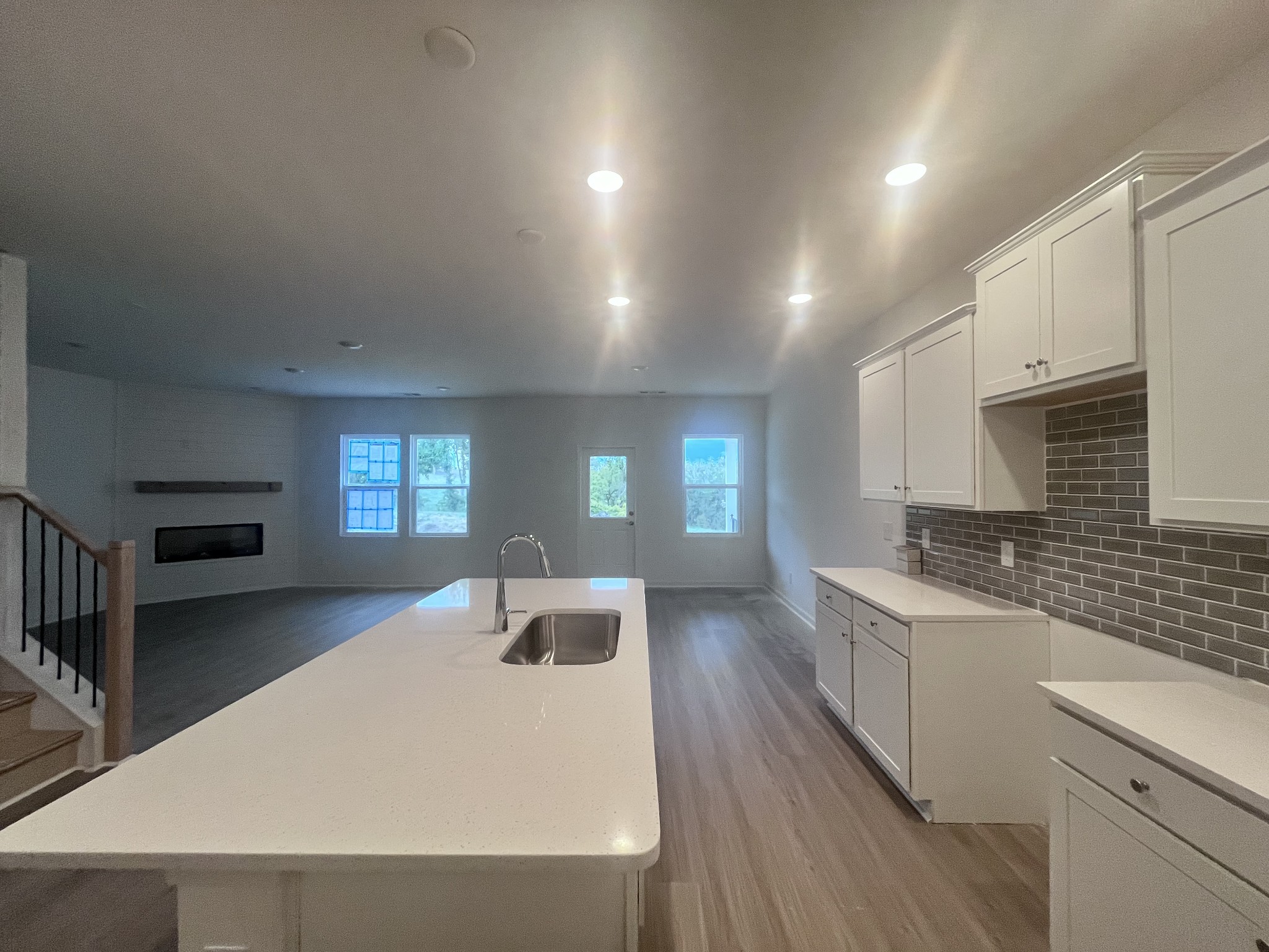 106 Glacier Way Gorgeous White Kitchen and Island to Dining area (back right) and open to the Living Area with a beautiful Fireplace Feature wall!