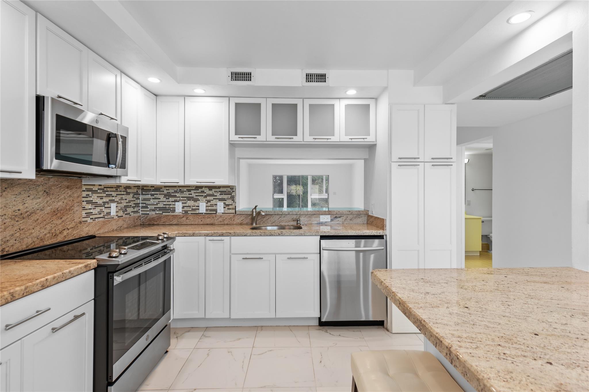 Gorgeous kitchen with tons of storage and white sh