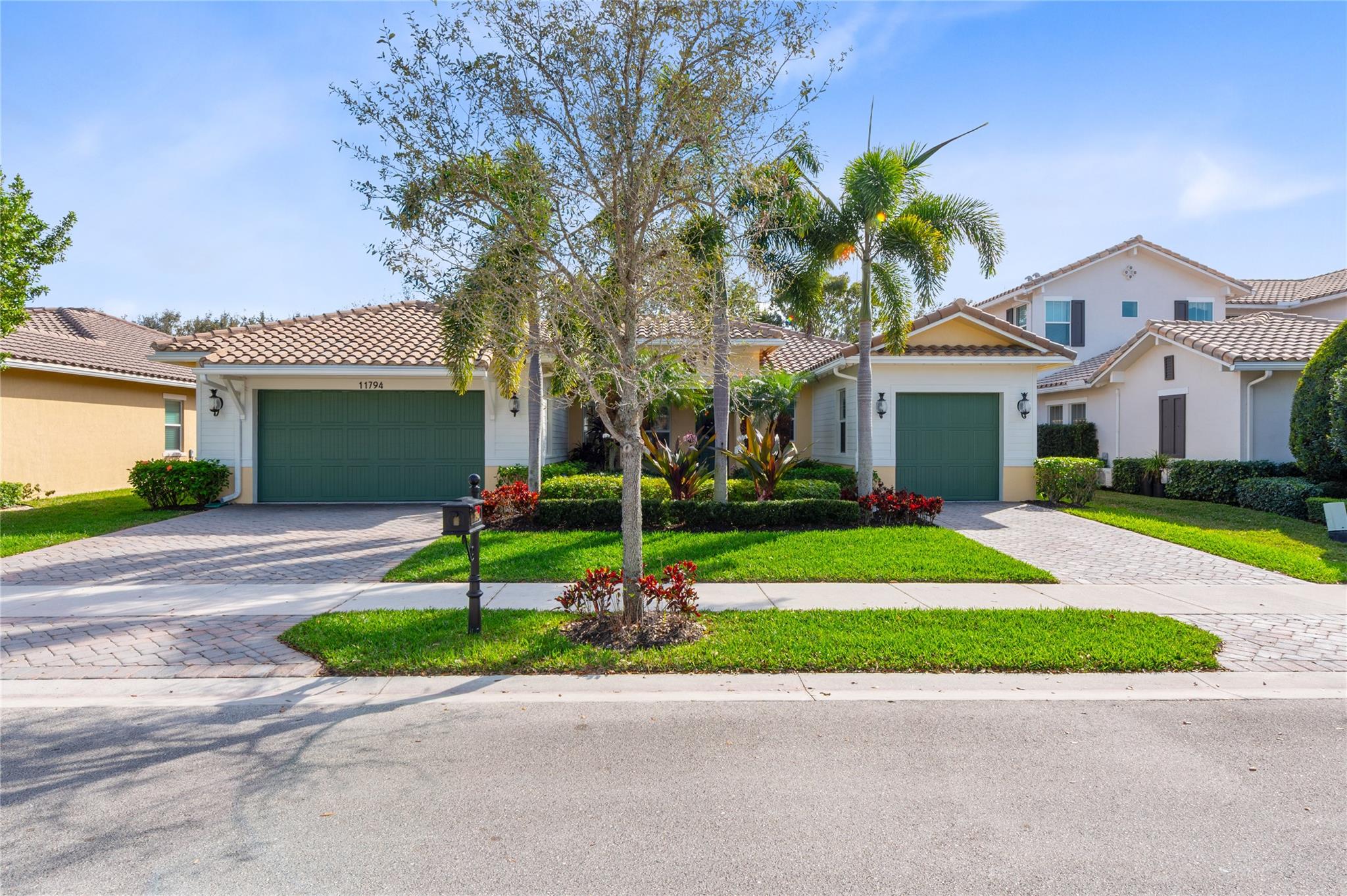 Stunning curb appeal with a lush, tropical landsca