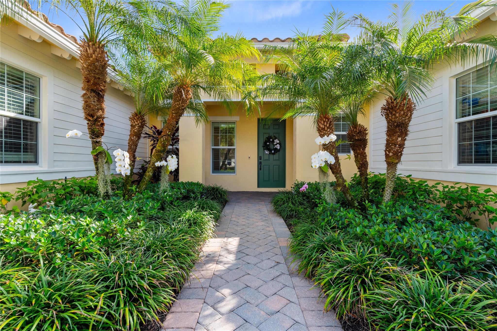 A beautifully landscaped pathway lined with lush g