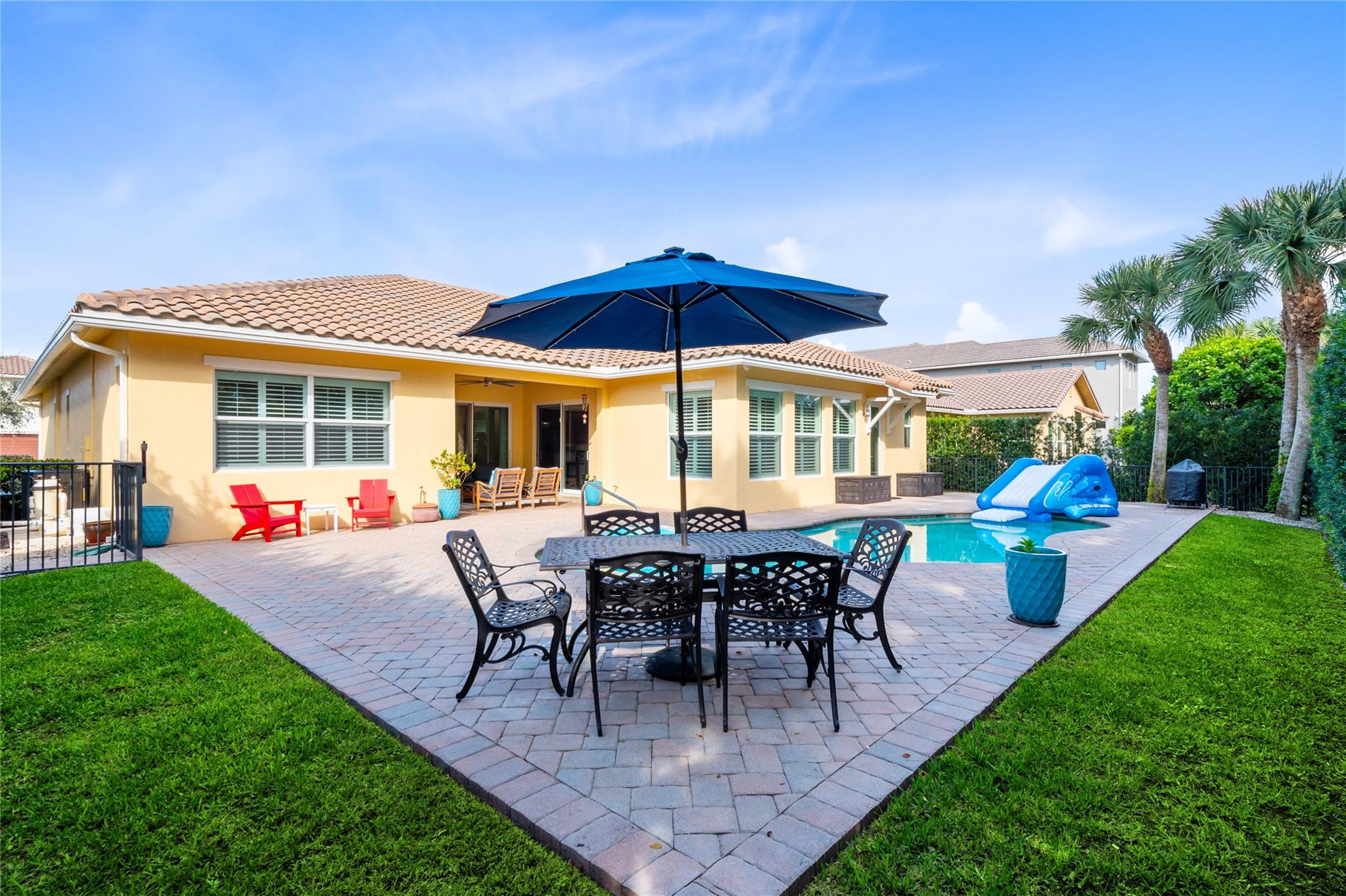 A vibrant backyard oasis featuring a sparkling poo