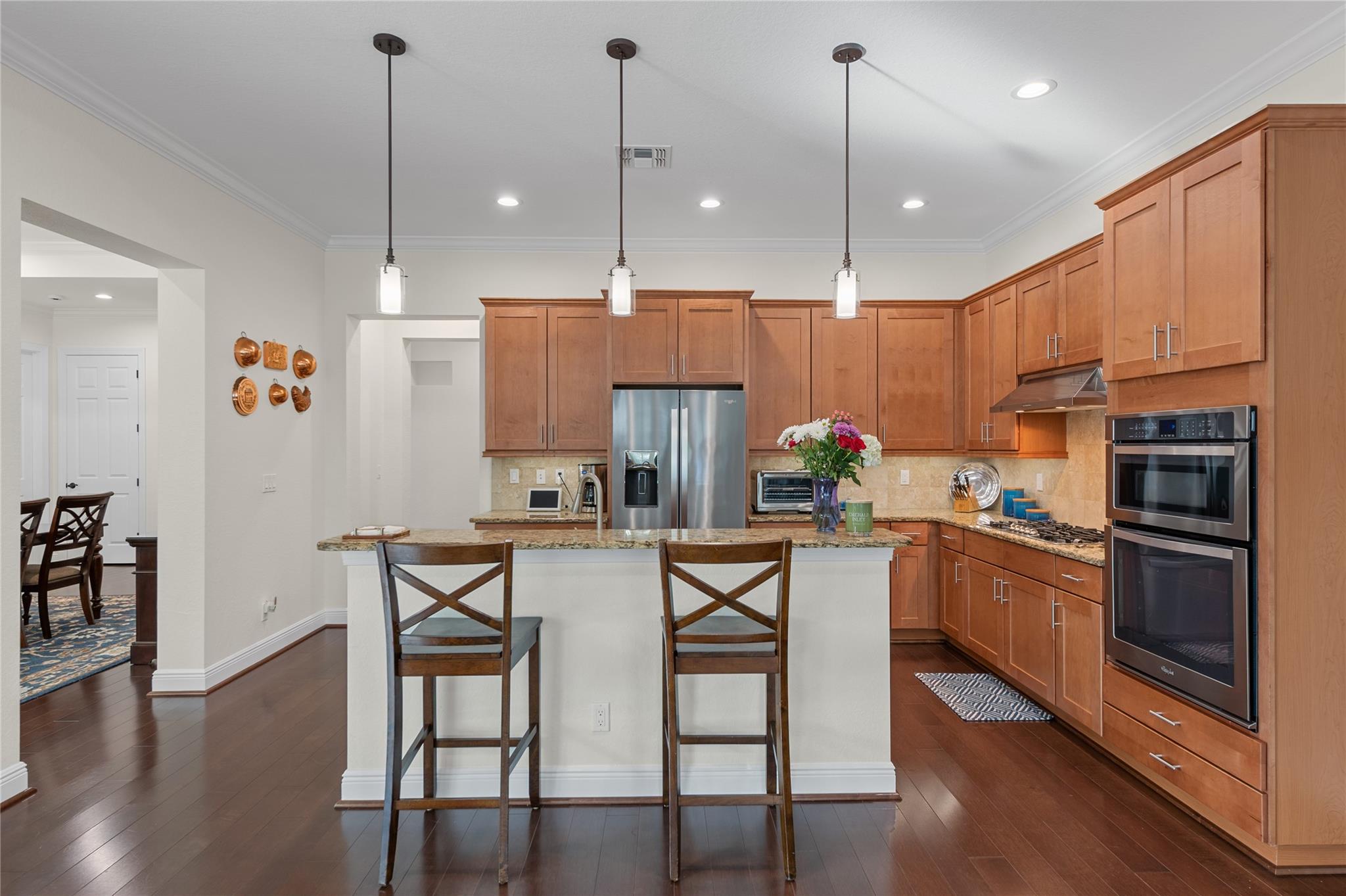 A spacious, modern kitchen featuring granite count