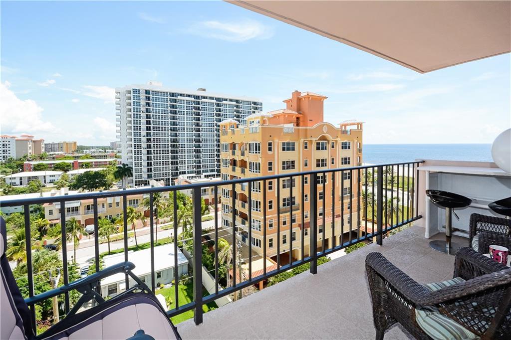 Infinity view of city and ocean from balcony