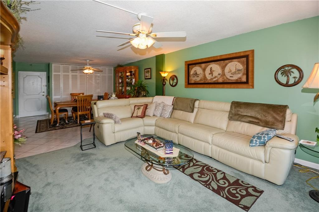 Large living room/entertainment area open to dinin