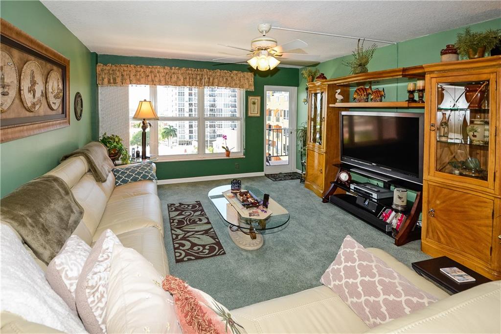 Living room with impact  glass door to balcony