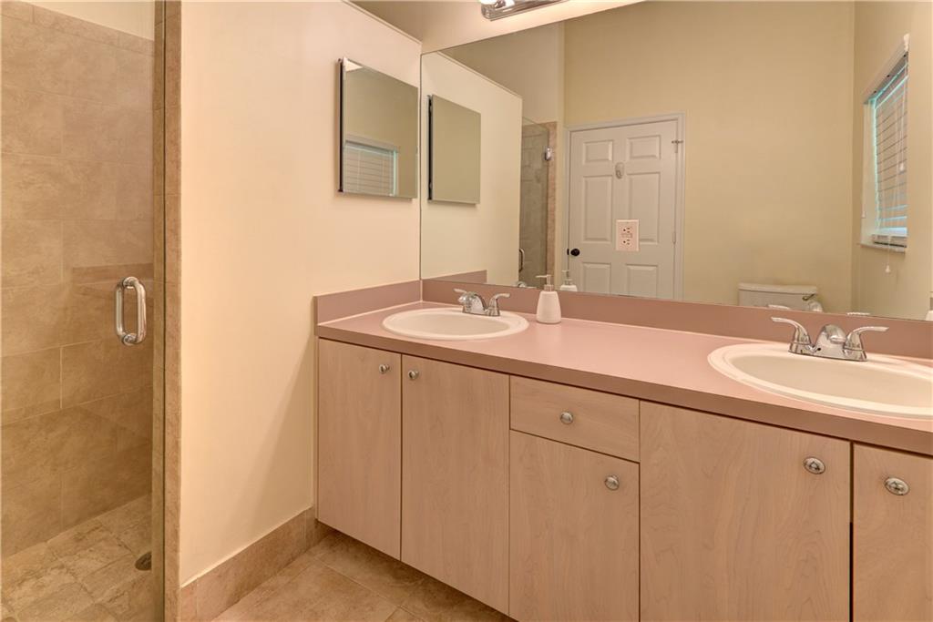 Master Bathroom with walk in shower and his and he
