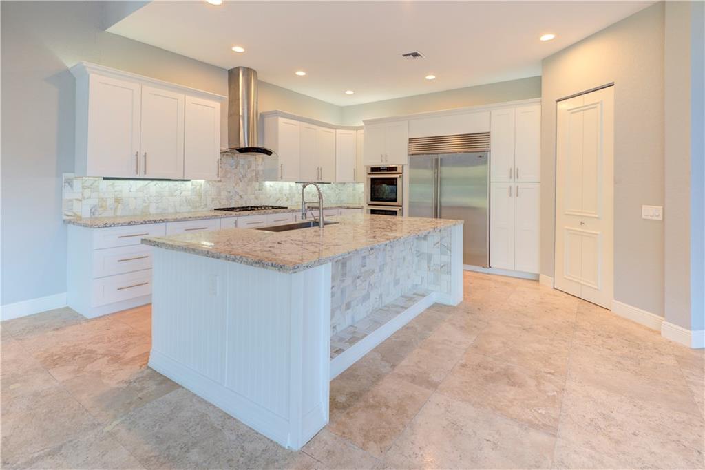 6565 Grande Orchid Way Modern kitchen with SubZero fridge.